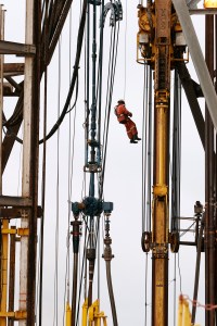 A worker abseils down the 180ft high drilling derrick on the Jack Ryan drill ship, which worked in block 31, Angola. (photo courtesy of BP p.l.c.)